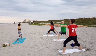 Practicing yoga on the beach